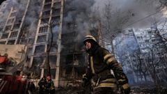 A firefighter walks outside a destroyed apartment building after a bombing in a residential area in Kyiv, Ukraine, on March 15. (Photo / AP)