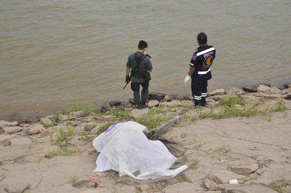 Thai rescuers cover a body on the shore of the Mekong River in Nakhon Phanom province northeast of Bangkok, Thailand, Thursday Dec. 27, 2018. (AP Photo, File)