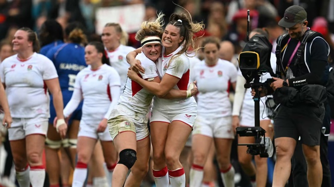 England's centre Megan Jones and wing Jess Breach celebrate on the field after the Women's Rugby World Cup semifinal win over France. Photo / AFP