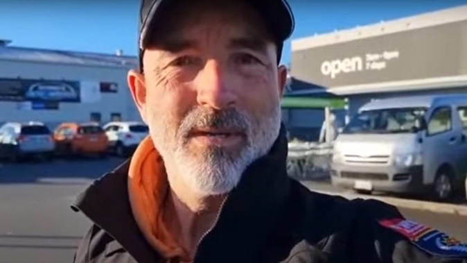 A screenshot from the video published online showing a man wearing a Fire and Emergency jacket being refused entry to Countdown for not wearing a face mask. (Photo / File)