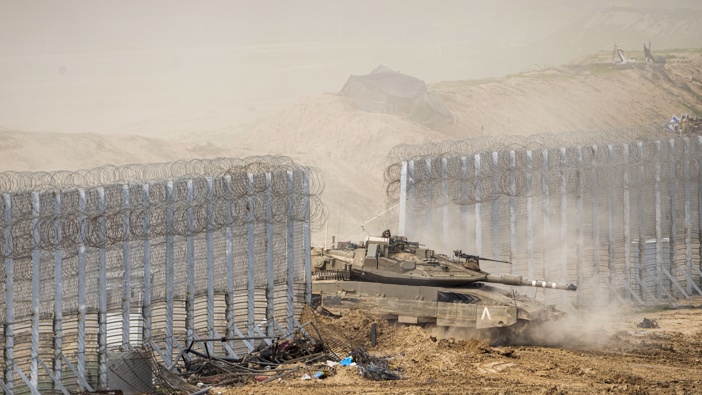 Israeli soldiers drive a tank as they cross the border from inside Gaza Strip in to southern Israel, Tuesday, Feb. 13, 2024. Photo / AP