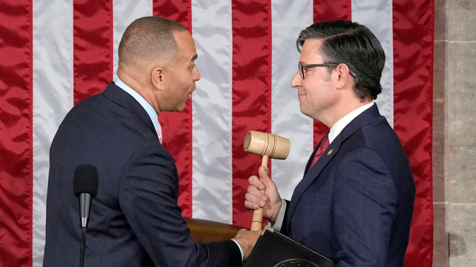 House Minority Leader Hakeem Jeffries of New York City hands the gavel to speaker-elect Mike Johnson, R-La, at the Capitol in Washington today. Photo / AP