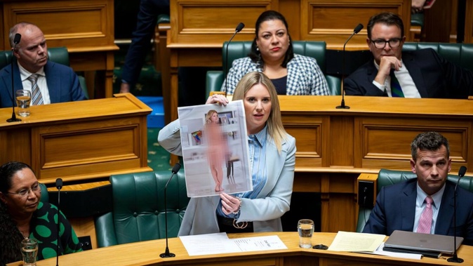 Act MP Laura McClure shows an AI-generated deepfake nude photo of herself in the House. Photo / Supplied