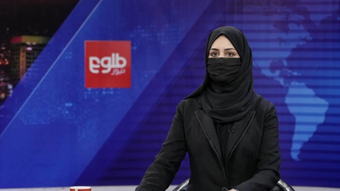 Khatereh Ahmadi a TV anchor wears a face covering as she reads the news on TOLO NEWS, in Kabul, Afghanistan. Photo / AP