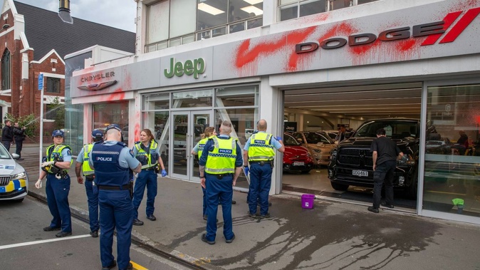Police rushed to the scene after the car dealership was sprayed with red paint on Thursday. Photo / Mark Mitchell