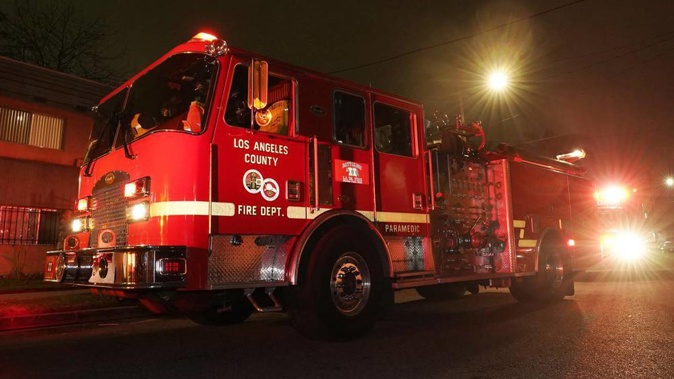 Los Angeles County Fire Department vehicles sit at a medical call in Inglewood, California. First responders are wondering how long they can keep working effectively as Covid cases increase in their ranks. Photo / AP