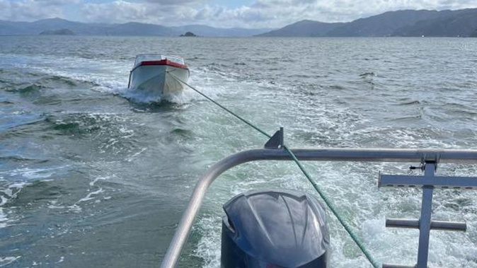 Wellington Maritime Police Unit tows the Hustler back to shore the day after it sank.