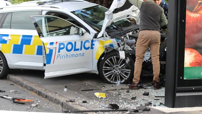 A major road in central Auckland has been closed after a significant incident involving a police car crashing into a bus stop. Photo / Jed Bradley