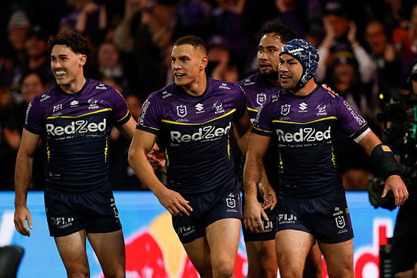 Jahrome Hughes (R) of the Storm celebrates scoring a try with Nick Meaney (L) and Will Warbrick of the Storm during the NRL Preliminary Final match between the Melbourne Storm and Cronulla Sharks at AAMI Park on September 26, 2025, in Melbourne, Australia. (Photo by Darrian Traynor/Getty Images)