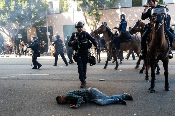 LAPD officers on horseback clash with protesters during protests after a series of immigration raids on June 8, 2025 in Los Angeles, California. Photo / Spencer Platt / Getty Images