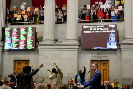 Representative Ryan Williams, R-Cookeville, right, watches his bill to allow some teachers to be armed in schools pass the House as others react during a legislative session in Nashville. Photo / AP