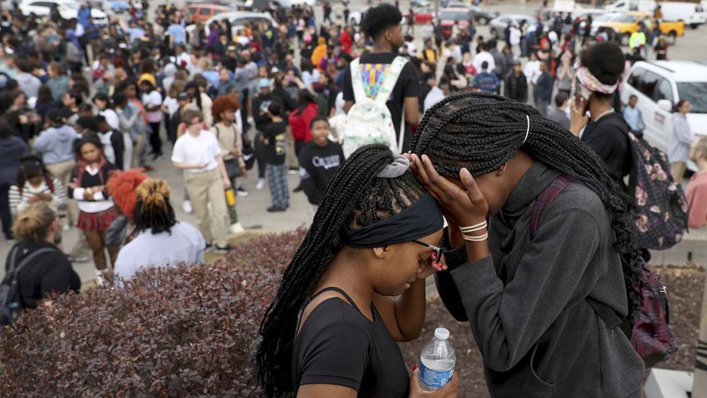 Students stand in a parking lot near the Central Visual & Performing Arts High School after a reported shooting in St Louis. Photo / AP