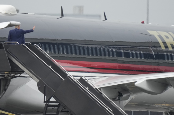 Former President Donald Trump waves as he boards his airplane at Newark Liberty International Airport. Photo / AP