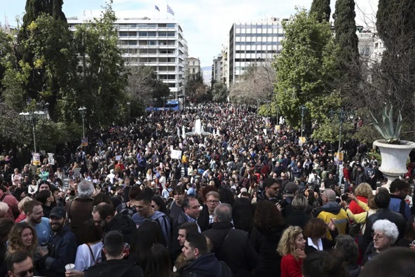 People gather during a protest at Syntagma square, in Athens, Greece, Sunday, March 5, 2023. Thousands protesters, take part in rallies around the country for fifth day, protesting the conditions that led the deaths of dozens of people late Tuesday, in Greece's worst recorded rail accident. The banner reads "It wasn't human error." (AP Photo/Yorgos Karahalis)