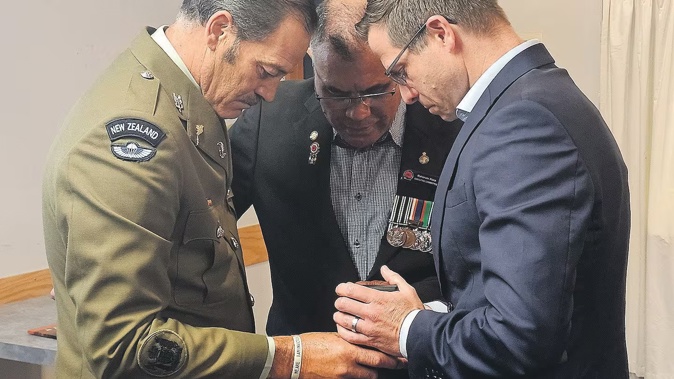 Whakatāne RSA Padre Raharuhi Koia provides a prayer as Warrant Officer Willie Apiata hands his Victoria Cross medal to Minister for Veterans Chris Penk. Photo / Diane McCarthy
