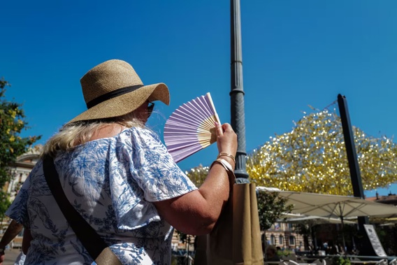 A person holds a fan due to the intense heat and heatwave on the Place du Capitole in Toulouse, France, in August. Photo / AFP