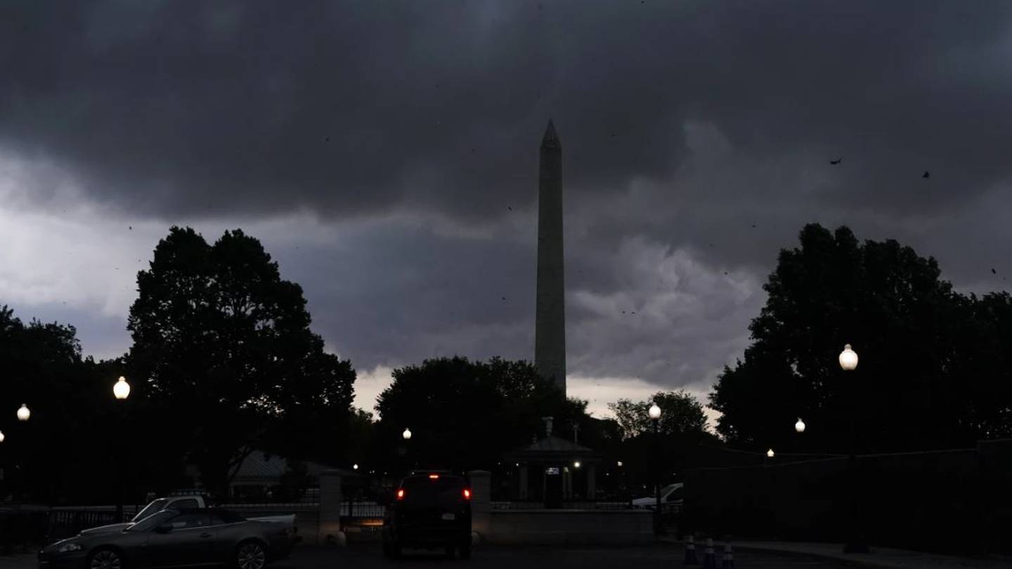Storm clouds darken the sky over the Washington Monument. Photo / AP