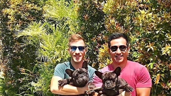 Daniel Kuntz, left, holding his dog named Bull, and his fiancé Eugene Marshall holding Lulu. (Photo / Supplied)