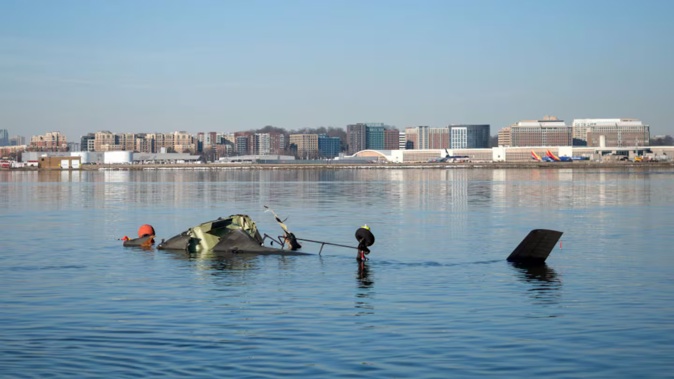 In this US Coast Guard handout, the Coast Guard investigates aircraft wreckage on the Potomac River on January 30 in Washington, DC. An American Airlines flight from Wichita, Kansas, collided midair with a military Black Hawk helicopter while on approach to Ronald Reagan Washington National Airport outside of Washington, DC. According to reports, there were no survivors among the 67 people onboard both aircraft. Photo / Petty Officer 1st Class Brandon Giles, US Coast Guard via Getty Images)