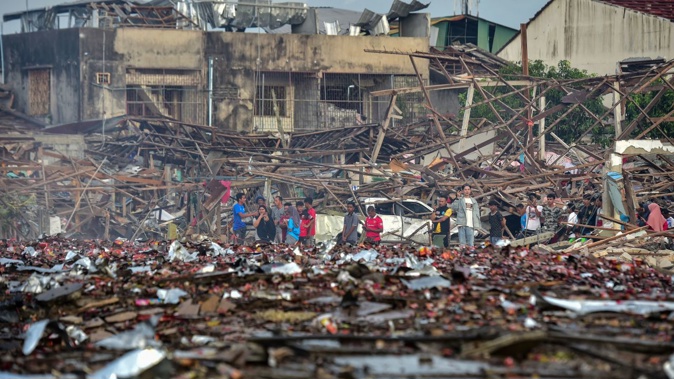 People look at the aftermath of destroyed homes after an explosion ripped through a firework warehouse in the southern Thai province of Narathiwat on July 29, 2023. Madaree Tohlala/AFP/Getty Images
