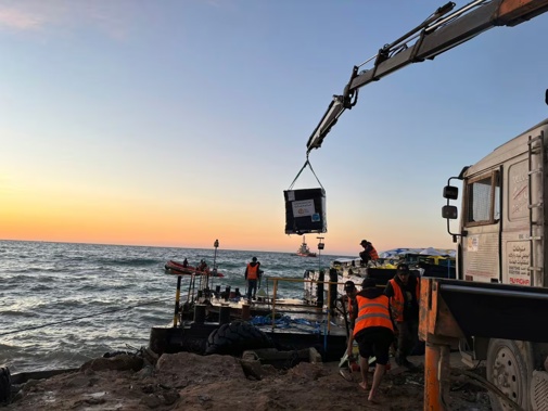 This photo provided by World Central Kitchen shows a crane unloading food packages over a makeshift port on the Gaza Strip. Photo / AP