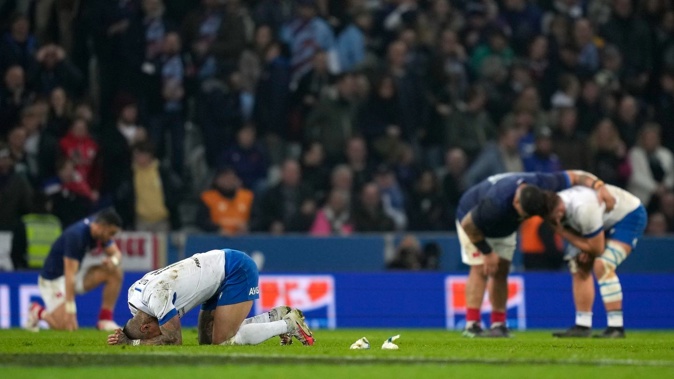 Players sink to the pitch at the end of the Six Nations rugby union international between France and Italy at the Pierre Mauroy stadium in Villeneuve d'Ascq. Photo / AP Photos
