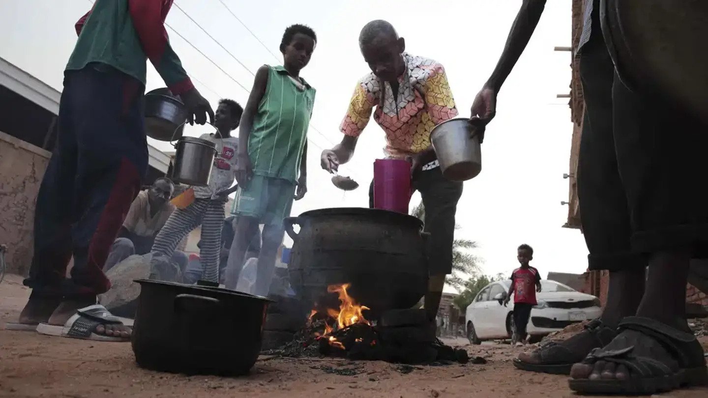 People prepare food in a Khrtoum neighbourhood. Photo / AP