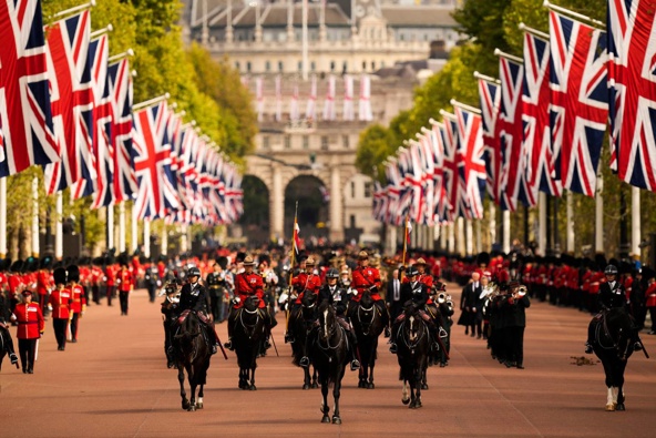 Police and military personnel parade down the Mall as the coffin of Queen Elizabeth II is carried following her funeral service in Westminster Abbey. Photo / AP