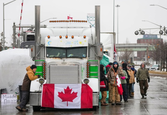 Truckers and supporters block the access leading from the Ambassador Bridge, linking Detroit and Windsor, as truckers and their supporters continue to protest against Covid mandates. (Photo / AP)