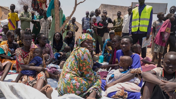 South Sudanese who fled from Sudan sit outside a nutrition clinic at a transit center in Renk, South Sudan, on May 16, 2023.