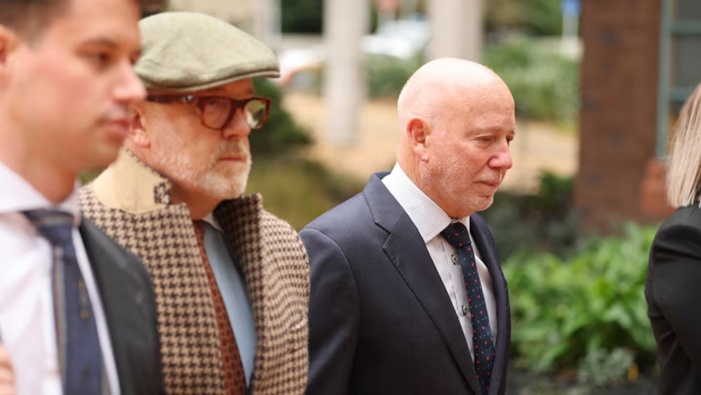 Phillip Polkinghorne, right, arrives at the High Court at Auckland with his lawyers. He's accused of having murdered wife Pauline Hanna and staged her death as a suicide. Photo / Michael Craig