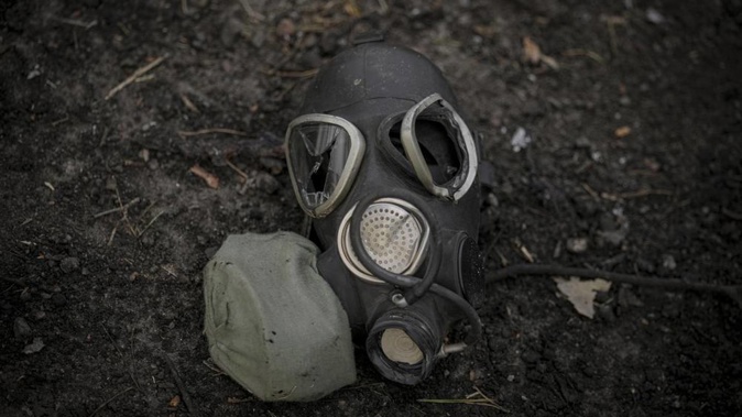 A damaged gas mask lies on the pavement at a Russian position which was overran by Ukrainian forces, outside Kyiv, Ukraine. Photo / AP