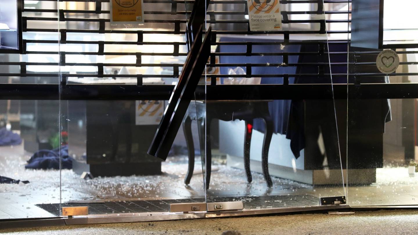 Smashed window glass after two people were seen breaking into Takapuna's Fifth Avenue Jewellery store and fleeing the scene. (Photo / Hayden Woodward)