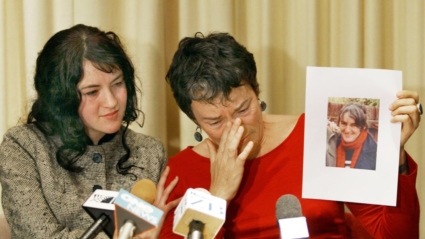 Christine Hindson's daughter, Marla Thompson (left), and Megannan, who holds a picture of her sister. 