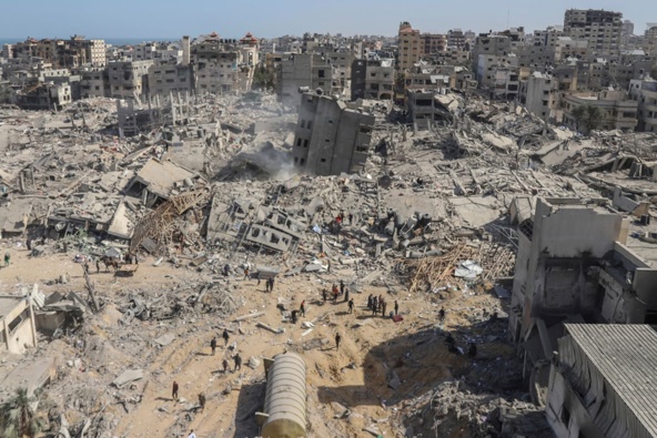 Palestinians walk through the destruction left by the Israeli air and ground offensive on the Gaza Strip near Shifa Hospital in Gaza City, Photo / AP