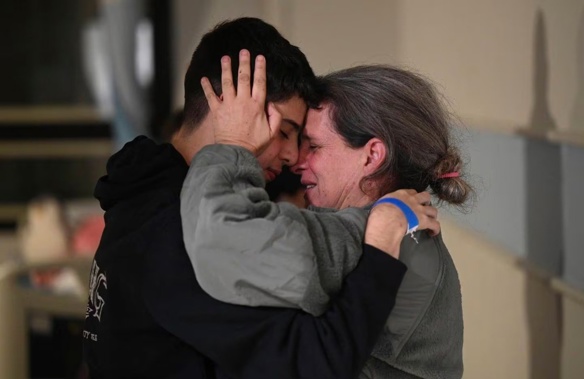 Sharon Hertzman, right, hugging a relative as they reunite at Sheba Medical Center in Ramat Gan, Israel. Sharon Hertzman and her daughter Noam, 12 years old, not pictured, were released by Hamas after being held as hostages in Gaza for 50 days. Photo / AP