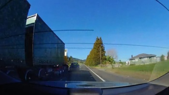 Watch: Alleged drunk driver weaves across state highway narrowly missing trucks