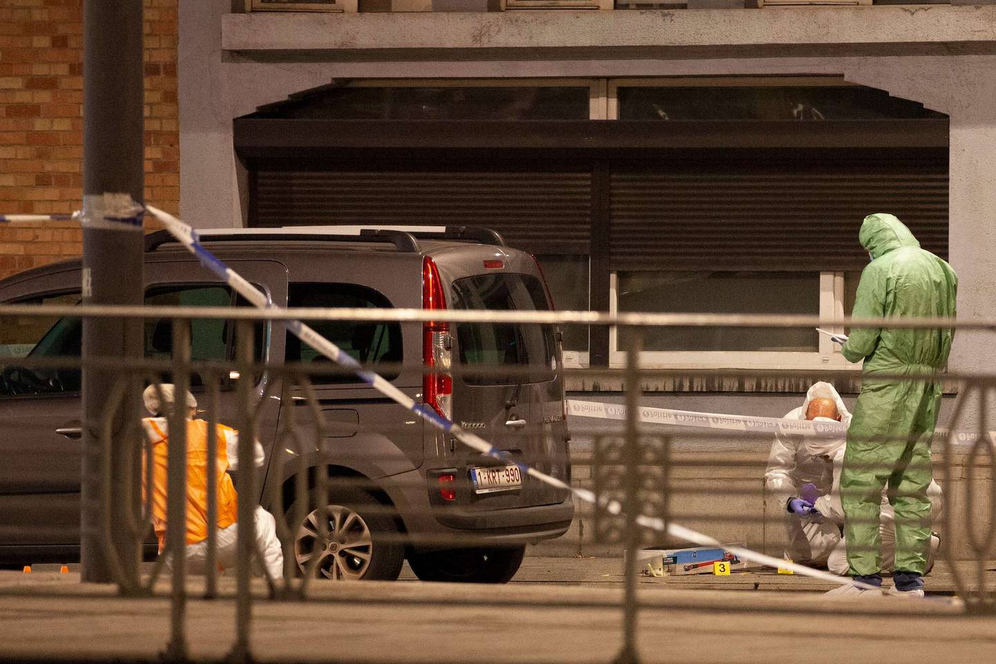 Police and inspectors work in an area where a shooting took place in the centre of Brussels. Photo / AP