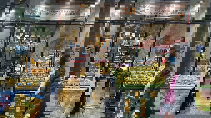 Residents walk past reopened stores in the district of Haizhu as pandemic restrictions are eased in southern China's Guangzhou province. Photo / AP