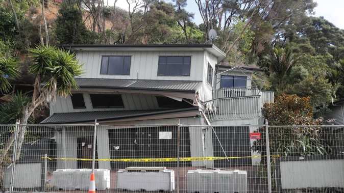 A red-stickered house on Scenic Drive, Swanson, at risk of collapsing in Auckland. Photo / Dean Purcell