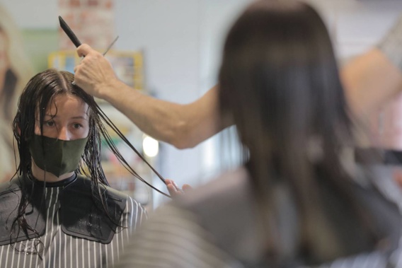 Alice Gray gets her hair cut from Hakan Altan, the owner of Hedzabove salon in Kohimaramara. (Photo / Michael Craig)