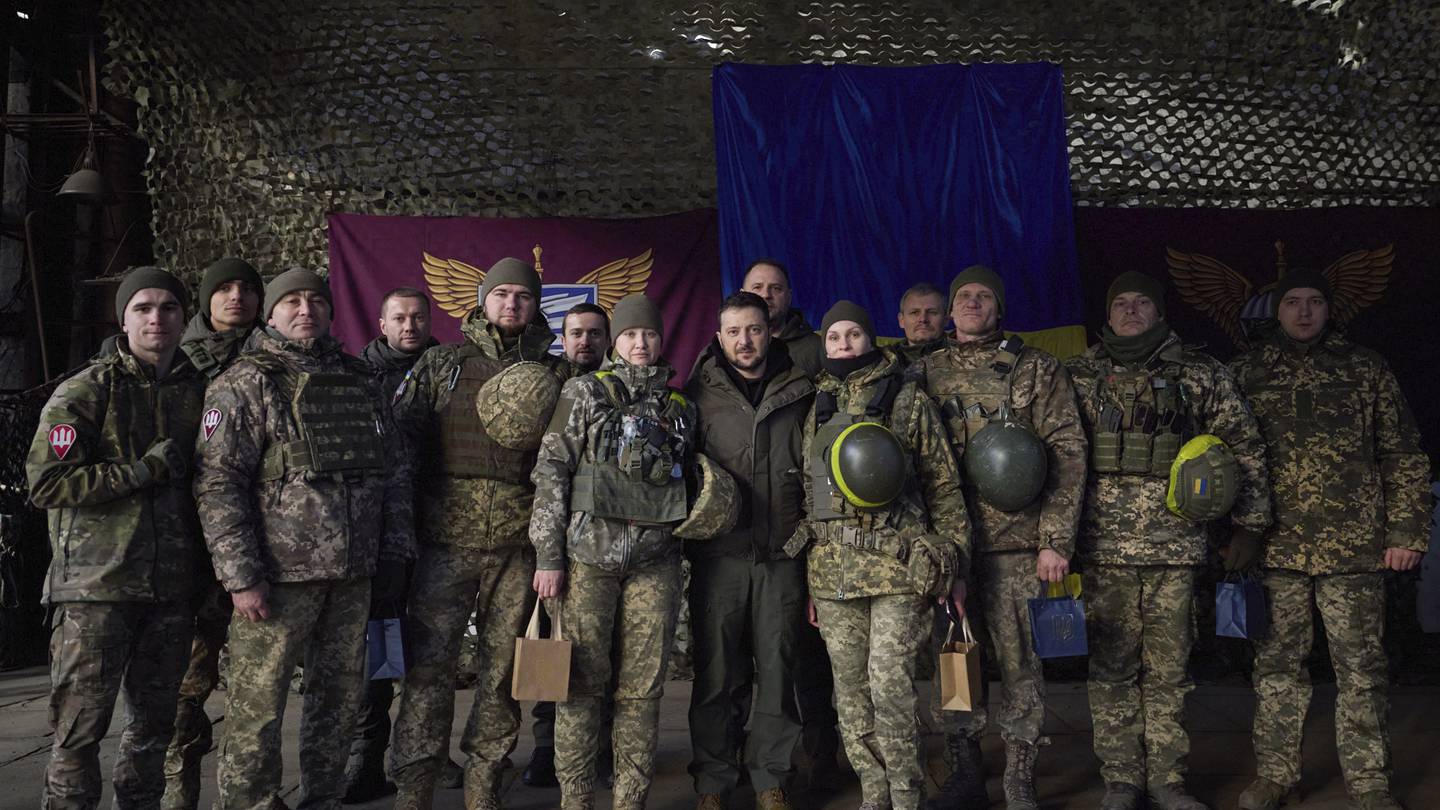 Ukrainian soldiers pose for a photo with President Volodymyr Zelenskyy, centre, during his visit to Sloviansk, Donbas region, Ukraine. Photo / Ukrainian Presidential Press Office via AP