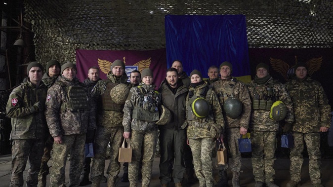 Ukrainian soldiers pose for a photo with President Volodymyr Zelenskyy, centre, during his visit to Sloviansk, Donbas region, Ukraine. Photo / Ukrainian Presidential Press Office via AP