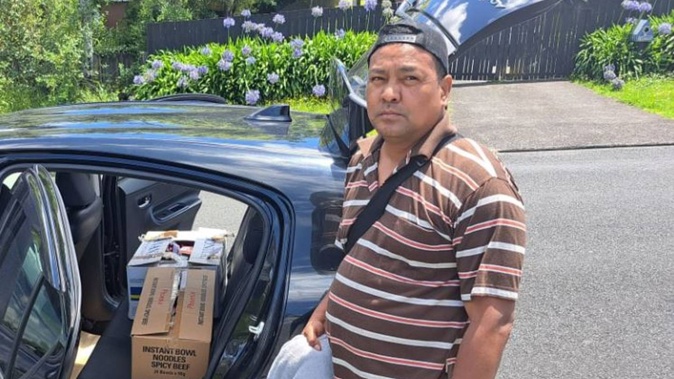 Red Aguhar beside the car he's sleeping in. Photo / RNZ / Luka Forman