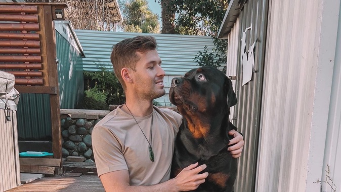 Ryan Tarawhiti-Brown with Chopper the dog.