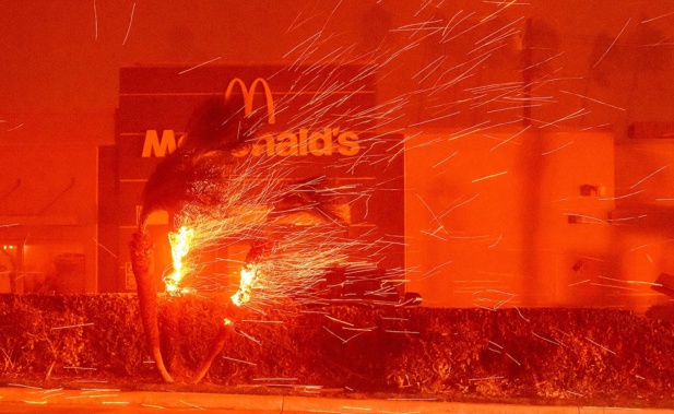 A McDonald's restaurant is showered in embers during the Eaton fire in Pasadena, California. Photo / AFP