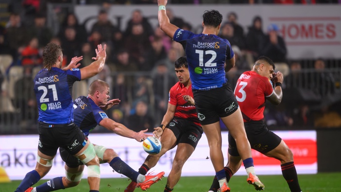 Adrian Choat, Anton Segner and AJ Lam of the Blues (L-R) attempt to block a kick from Taha Kemara of the Crusaders during the round 10 Super Rugby Pacific match between Crusaders and Blues at Apollo Projects Stadium, on April 18, 2025, in Christchurch, New Zealand. (Photo by Kai Schwoerer/Getty Images)