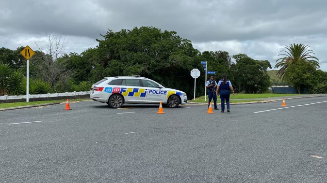 Armed police on Church Rd and Cliff St intersection in Onerahi. Photo / Denise Piper