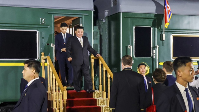 North Korea's leader Kim Jong Un, centre, steps down from his train after crossing the border to Russia at Khasan, about 127km south of Vladivostok, Russia. Photo / AP