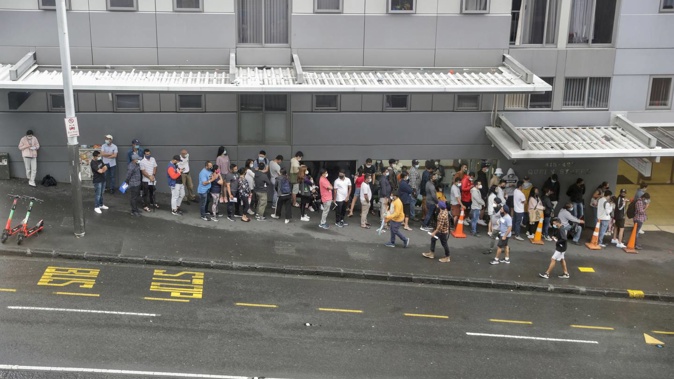 Hundreds of people queuing outside Auckland City Doctors on Queen St. Photo / Michael Craig